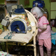 Lillard demonstrates how to use the ad hoc mechanisms on her iron lung. Photo: Jennings Brown for Gizmodo